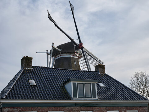 Close up of Traditional hulling and grist mill De Hoop with farmhouse in Holwerd, Netherlands