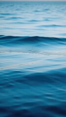 Naklejka premium Serene waves gently roll across a reflective lake at dawn with soft blue hues, calm, waves, serene