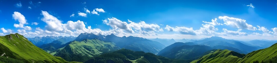 Fototapeta premium Panoramic photo of beautiful green mountains in the Alps, with a blue sky and white clouds. 