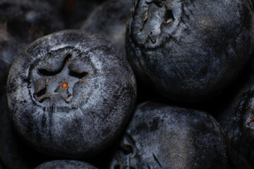 Detailed shot of ripe blueberries, highlighting their matte surface and vibrant color in a clustered arrangement.