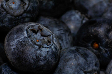 Detailed shot of ripe blueberries, highlighting their matte surface and vibrant color in a clustered arrangement.