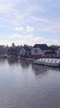 View down the River Bure captured from the Bridge in Wroxham. Vertical format footage optimized for reels, stories and social media platforms.