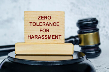 Zero Tolerance For Harassment text written on wooden board with lawyer gavel background. Harassment...