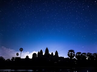 Naklejka premium Silhouette of Angkor Wat Under a Starry Sky