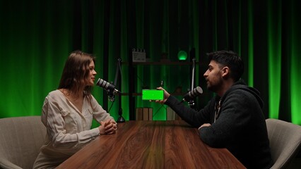 An engaging conversation with an expert in the cozy environment of a podcast studio with green light
