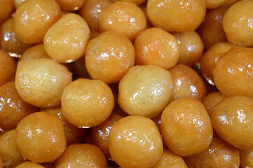Zalabia dessert, a type of middle eastern fried dough similar to that of a doughnut, a tasty dessert to serve at any holiday party, fried dough sweet foods with a honey sugary syrup, Zalabya