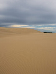 Beautiful sand dune landscape with cloudy sky.