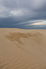 Sand dune with pattern on an overcast day.
