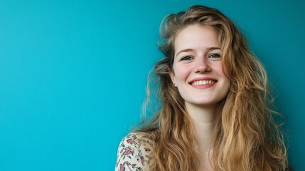 Cheerful long-haired girl exudes joy, vibrant energy radiates in a creative moment.
