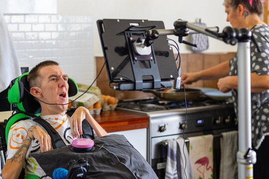 Young man with disability on his wheelchair looking at an acc screen