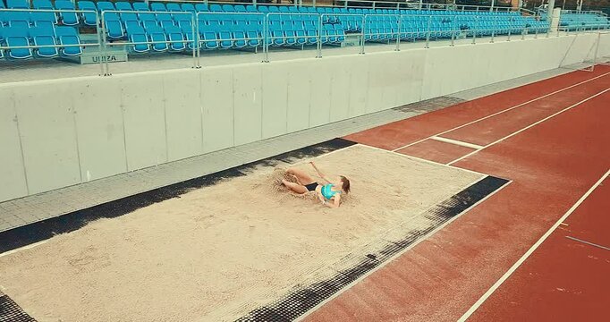 Long jump, A professional athlete girl trains at a stadium, preparing for a competition. Zilina, Slovakia, 28.06.2023
