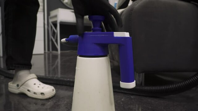 Cleaner mixes dry cleaning chemicals detergent with water to clean upholstered textile furniture and neutralize smell 4k video.