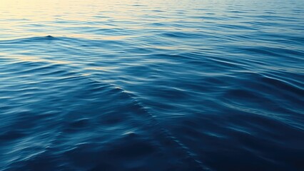 Serene waves gently roll across a reflective lake at dawn with soft blue hues, blue, serene, calm