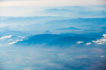 A view of the planet Earth, a view from an airplane, mountains and clouds