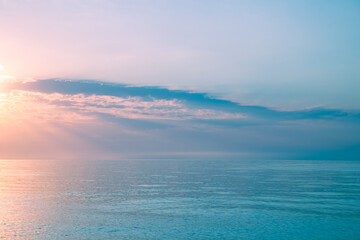Obraz premium Beautiful gentle and delicate pink sunrise on the sea, sky with clouds, natural delicate background