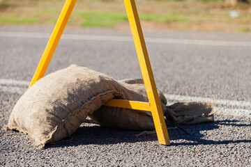 Sandbag holding roadwork sign up
