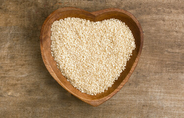 bowl of white sesame seeds in a heart shape