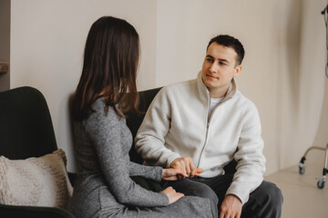 Couple engaged in a conversation in a modern indoor setting during daytime