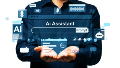 Man in dark shirt holding AI assistant holographic interface with digital icons on white background. Concept of artificial intelligence technology