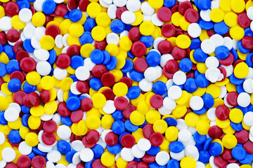 Colorful Round Discs in Vibrant Red, Yellow, Blue, and White Colors