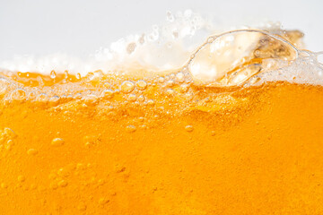 Close up bright orange Oil or beer splash texture and nature waves, Beautiful waves curve and little bubbles smooth for graphic design and background, Oil Bubbles, Soft beer bubbles, Selective focus
