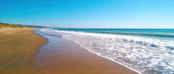 serene beach setting with gentle waves lapping at shore under clear blue sky