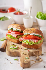 Bbold sandwich made with salami, cucumber, and tomato.