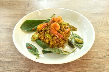 spicy fried chop pork and shrimp with turmeric curry Thai southern style food on plate