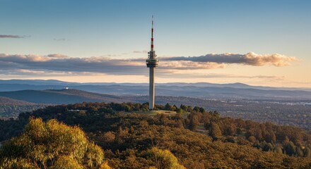 Obraz premium Tall communications tower on hill with scenic landscape view