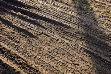 car wheel tracks on wet ground, bad road