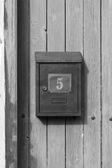 House number 5 (five) on mail box in black and white