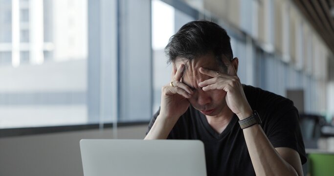 Asian businessman burn out on failed job in office. Elderly office worker expresses emotions Failed to work No success. Financial Communication Business problem. Working too hard overtime