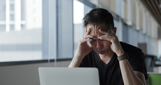 Asian businessman burn out on failed job in office. Elderly office worker expresses emotions Failed to work No success. Financial Communication Business problem. Working too hard overtime