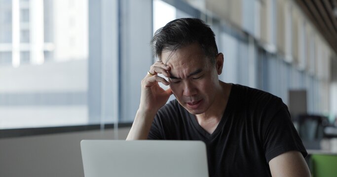Asian businessman burn out on failed job in office. Elderly office worker expresses emotions Failed to work No success. Financial Communication Business problem. Working too hard overtime