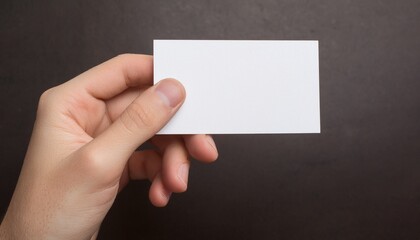 a hand holding a blank white business card. It's a simple, clean, and minimalist shot, perfect for showcasing your business or brand.