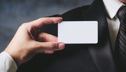 a person holding a blank business card, the business person is wearing formal wear