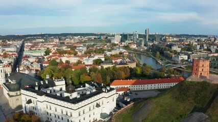 Aerial view of the historic heart of Vilnius, featuring Gediminas' Tower and Cathedral Square at sunrise.