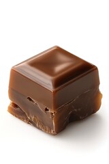 A close-up of a rich, glossy chocolate caramel cube on a white background.