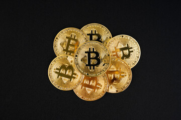  Heap of Golden Bitcoin on Black Leather Background.
