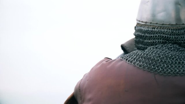 Historical reenactment &ndash; a warrior in armor with an axe awaits battle