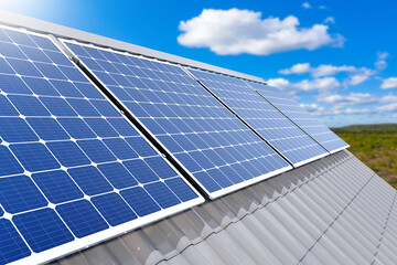 Solar panels on roof of building. Generators of electricity from sunlight. Solar panels under blue...