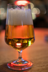 Golden Beer in Elegant Glass on Wooden Table