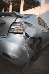 Insurance and Repairs. The damaged car represents the necessity of auto insurance, repair costs,...