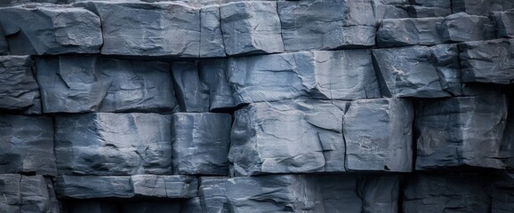 Fototapeta premium Jagged rock wall featuring a cliff edge texture illustrating natural erosion forces and geological composition