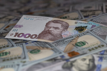1000 hryvnia banknote on 100 US dollar banknotes