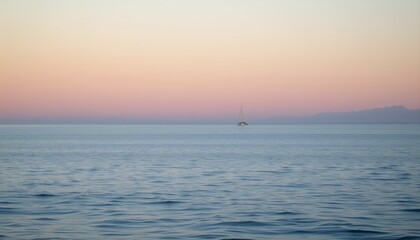  Serene sailboat floating on gentle ocean waves during a peaceful sunset