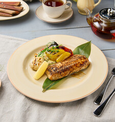 Gourmet Grilled White Fish Steak with Vibrant Vegetables in Rustic Setting