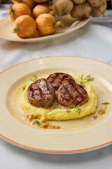 Gourmet Veal Medallions with Creamy Mashed Potatoes on Elegant Plate