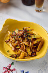 Golden Crispy Fried Potatoes with Onions in Warm Yellow Glow