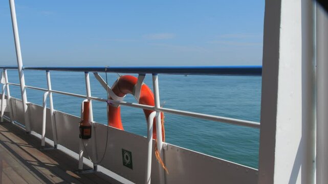 Scenic View from a Ferry with a Lifebuoy Overlooking the Calm Sea
